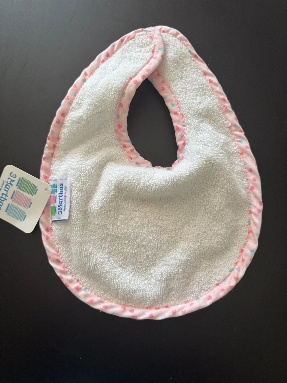 White Bib with Pink Trim and Pastel Crown Applique